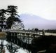 Japan: Crossing a bridge beneath Mount Fuji, T. Enami, c. 1910